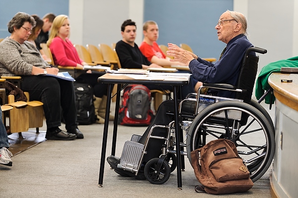 A professor in a wheelchair in a lecture.